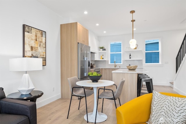 kitchen featuring modern cabinets, light wood-style flooring, open shelves, recessed lighting, and appliances with stainless steel finishes