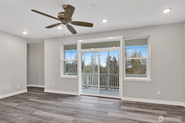 spare room featuring recessed lighting, wood finished floors, and baseboards