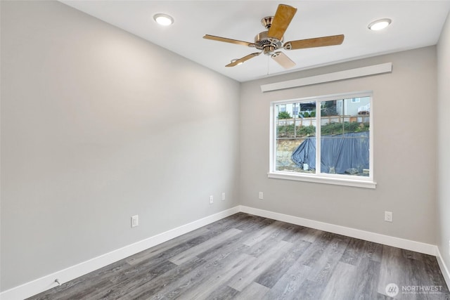 empty room featuring dark wood-style floors, recessed lighting, ceiling fan, and baseboards