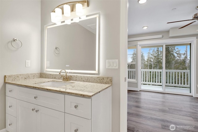 bathroom featuring vanity, wood finished floors, and a ceiling fan