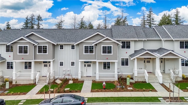 multi unit property with covered porch and roof with shingles