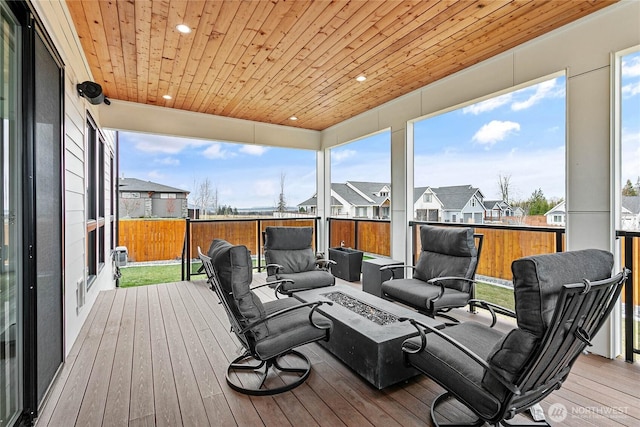 deck with a residential view and an outdoor living space with a fire pit