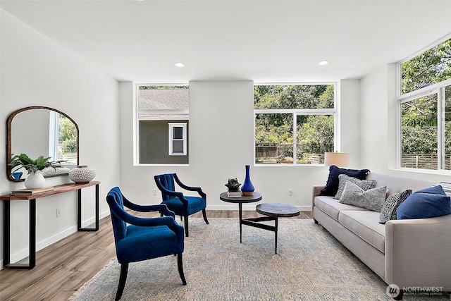 living area with recessed lighting, baseboards, and wood finished floors