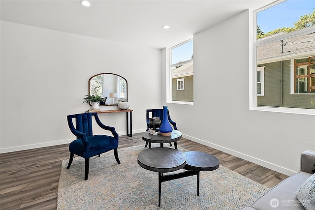 living area with recessed lighting, wood finished floors, and baseboards