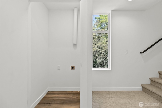 laundry room featuring baseboards, hookup for an electric dryer, dark wood finished floors, and laundry area