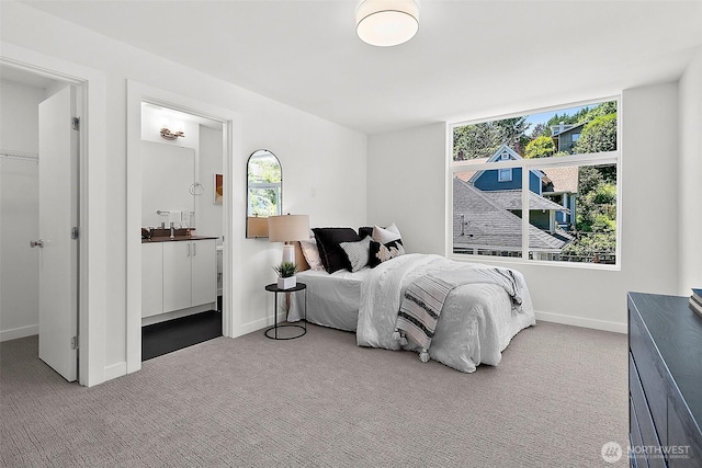 bedroom with baseboards, multiple windows, and carpet