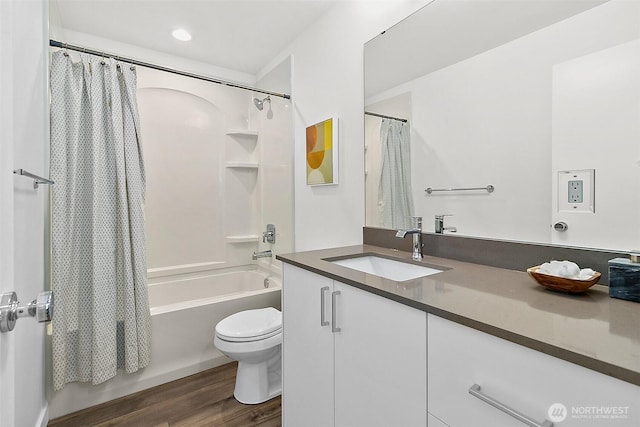 full bathroom featuring vanity, toilet, shower / tub combo with curtain, and wood finished floors