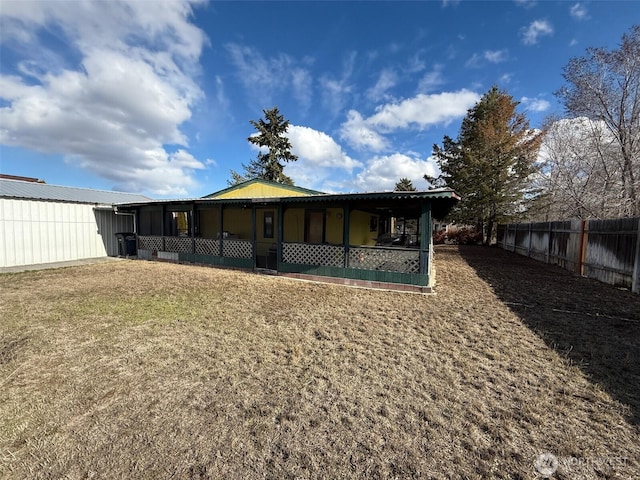 back of house with fence and a sunroom