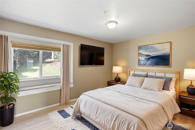 bedroom with baseboards and wood finished floors