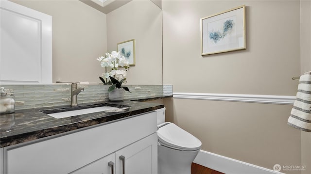 bathroom featuring vanity and toilet