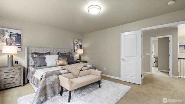 bedroom featuring light carpet and baseboards