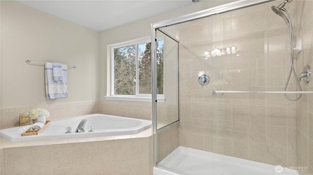 full bath with a stall shower and a garden tub