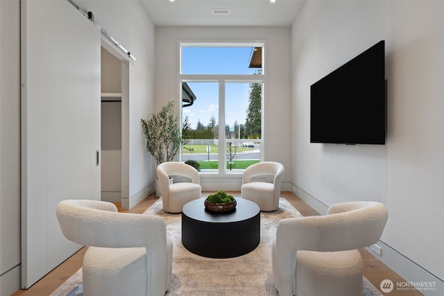 3119 Heron St, Woodland, WA 98674 - sitting room featuring light wood-type flooring, a barn door, baseboards, and visible vents