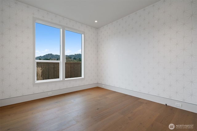 3119 Heron St, Woodland, WA 98674 - unfurnished room with baseboards, wood finished floors, and wallpapered walls