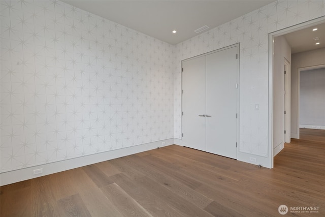 3119 Heron St, Woodland, WA 98674 - unfurnished bedroom featuring baseboards, wood finished floors, and wallpapered walls