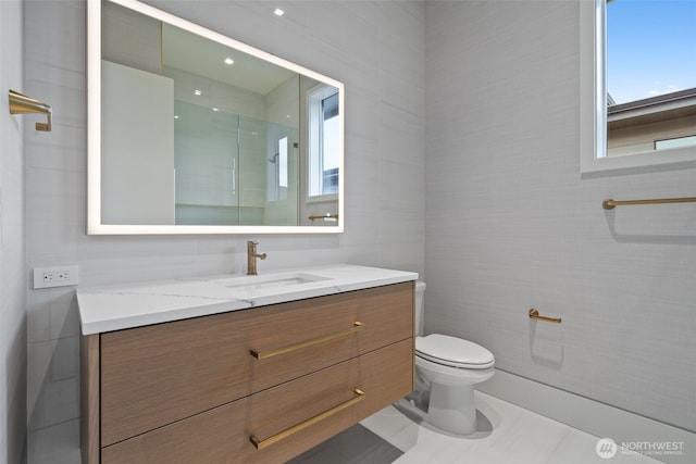 3119 Heron St, Woodland, WA 98674 - full bathroom with vanity, tile walls, toilet, and a shower