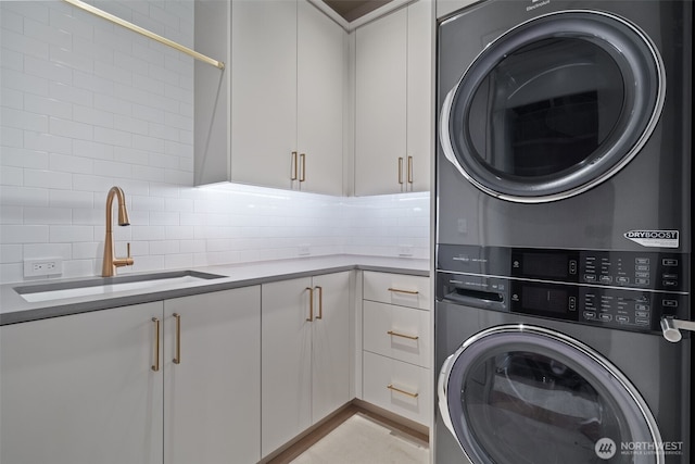 3119 Heron St, Woodland, WA 98674 - clothes washing area with stacked washer / dryer, cabinet space, and a sink