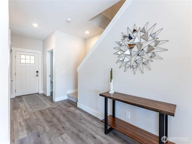 foyer entrance with stairs, recessed lighting, wood finished floors, and baseboards