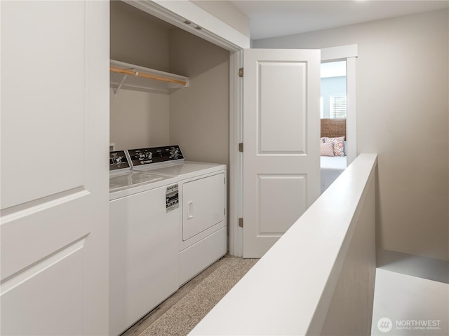 laundry area featuring washing machine and clothes dryer and laundry area