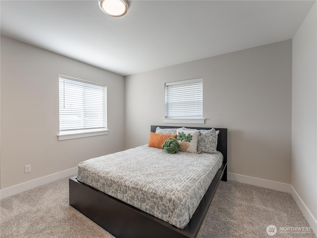 carpeted bedroom with baseboards and multiple windows