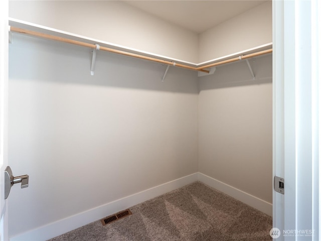 walk in closet featuring carpet flooring and visible vents