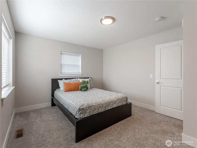 bedroom featuring visible vents, baseboards, and carpet