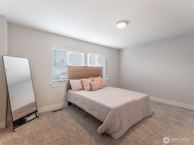 carpeted bedroom with visible vents and baseboards