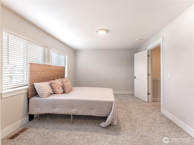 bedroom with visible vents, baseboards, and carpet