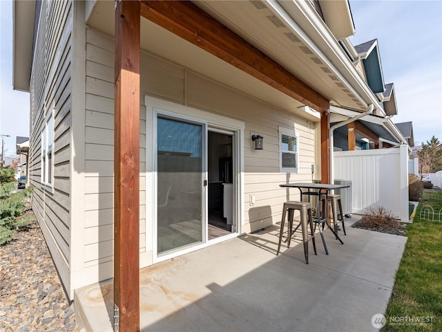 view of patio with central AC unit and fence