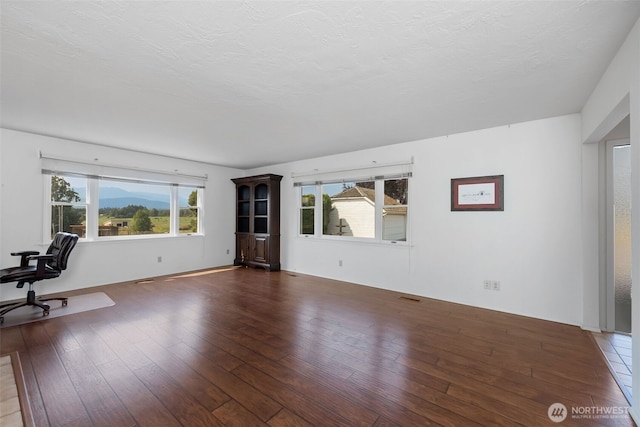 4596 Woodcock Rd, Sequim, WA 98382 - unfurnished living room with visible vents, hardwood / wood-style flooring, and a textured ceiling