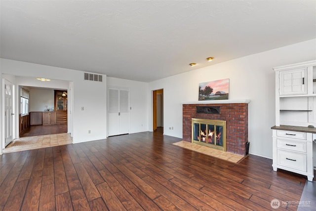 4596 Woodcock Rd, Sequim, WA 98382 - unfurnished living room with a fireplace, visible vents, and dark wood finished floors