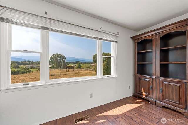 4596 Woodcock Rd, Sequim, WA 98382 - unfurnished room with visible vents, a mountain view, and dark wood finished floors
