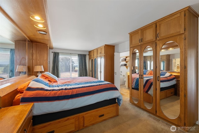4596 Woodcock Rd, Sequim, WA 98382 - bedroom with french doors, light colored carpet, and ensuite bathroom