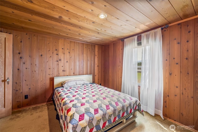 4596 Woodcock Rd, Sequim, WA 98382 - bedroom featuring wood walls, wooden ceiling, and carpet floors