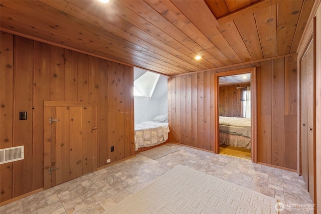 4596 Woodcock Rd, Sequim, WA 98382 - additional living space with wood ceiling, wooden walls, baseboards, and visible vents