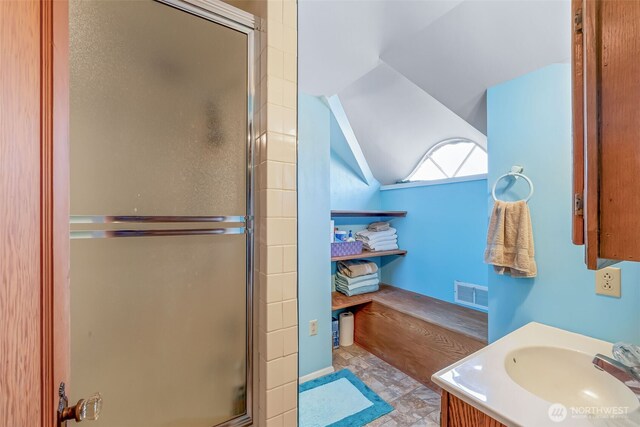 4596 Woodcock Rd, Sequim, WA 98382 - bathroom featuring visible vents, vaulted ceiling, vanity, and a shower with door