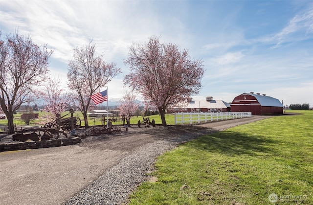 4596 Woodcock Rd, Sequim, WA 98382 - view of property's community with fence, an outdoor structure, a barn, and a lawn