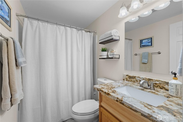 bathroom featuring toilet and vanity