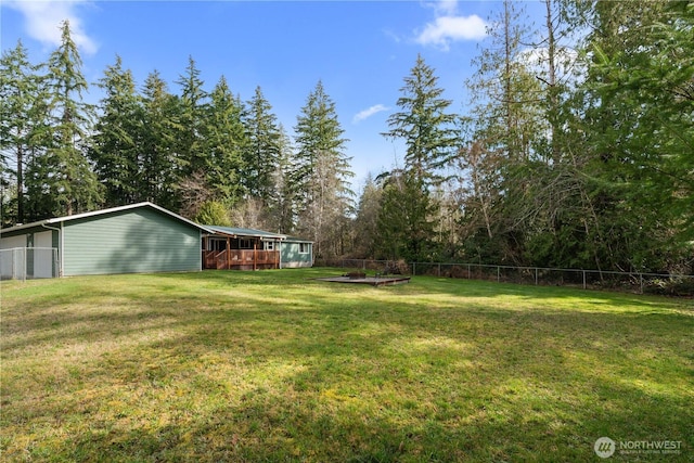 view of yard featuring a deck and fence