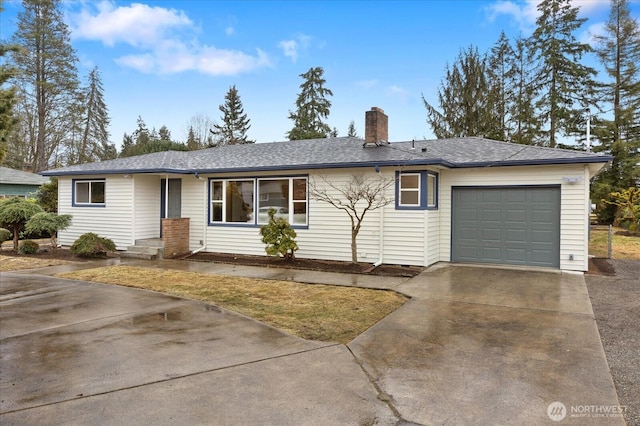 single story home featuring a chimney, concrete driveway, and a garage