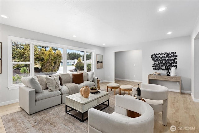 living area with recessed lighting, baseboards, and light wood-style floors