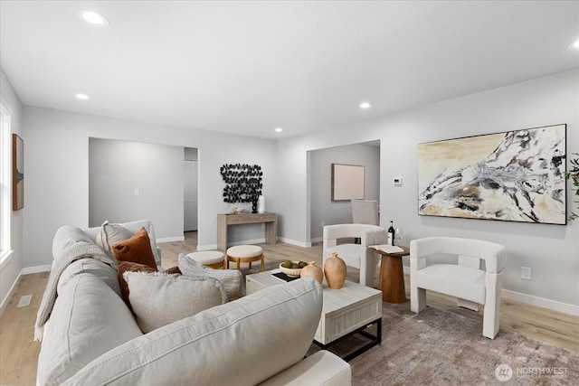 living room with recessed lighting, light wood-type flooring, and baseboards