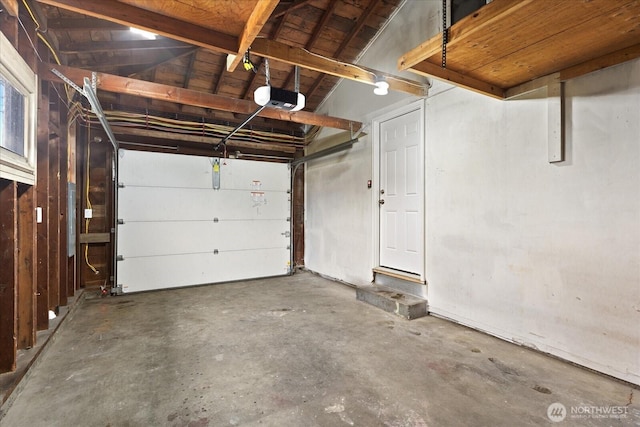 garage featuring electric panel and a garage door opener