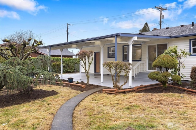 view of front facade with a carport and a front yard