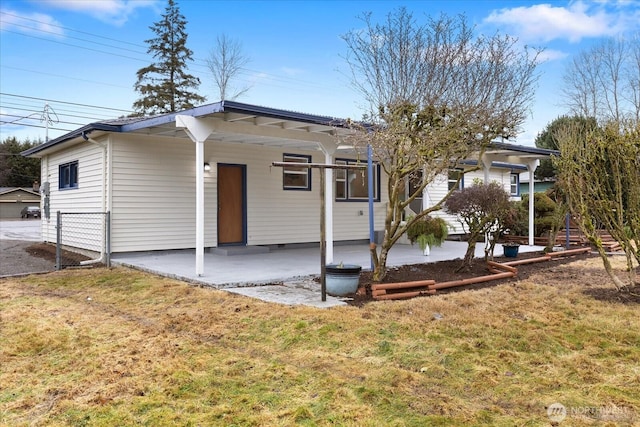 back of house featuring a patio, a yard, and fence