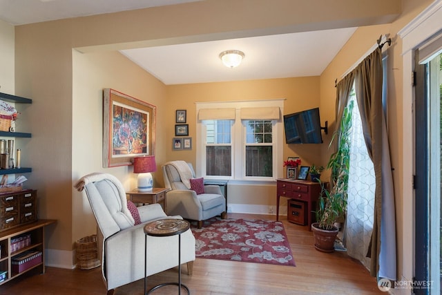 living area with wood finished floors and baseboards