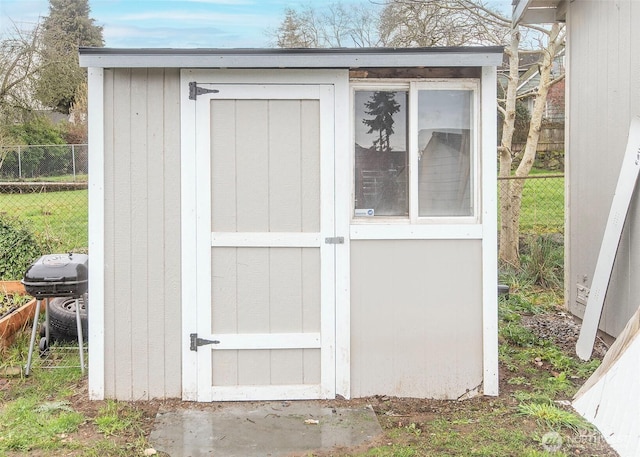 view of shed with fence