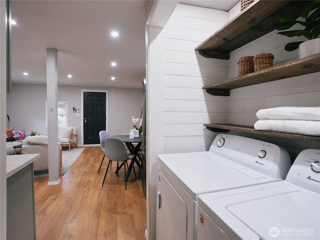 laundry area with laundry area, recessed lighting, light wood finished floors, and washer and clothes dryer