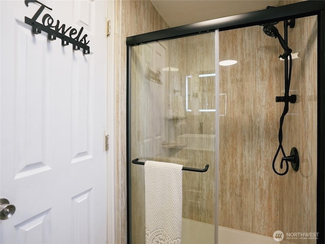 bathroom with a shower with door