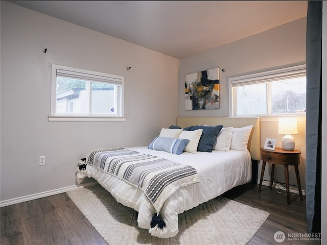 bedroom featuring dark wood finished floors and baseboards